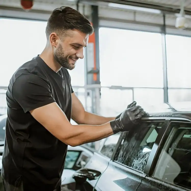 Man engaged incar dryclean at home, ensuring a spotless finish